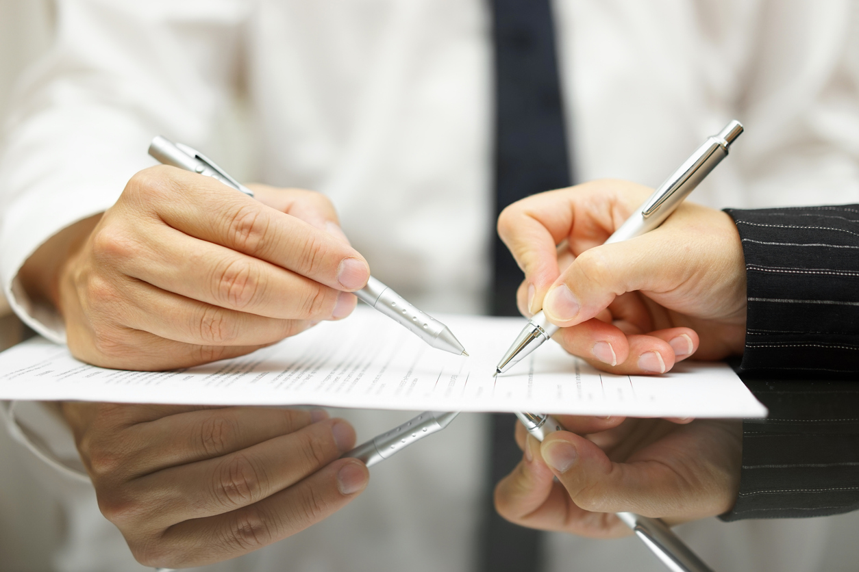 Businessman pointing out where to sign mortgage document