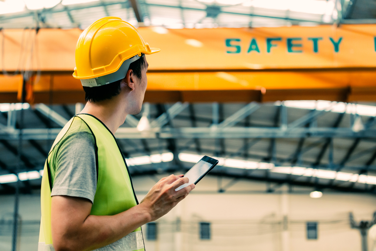 Factory worker using a digital tablet