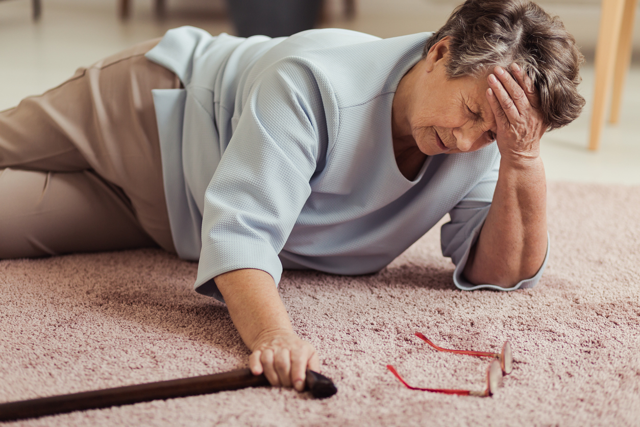 An elderly woman who has fallen down