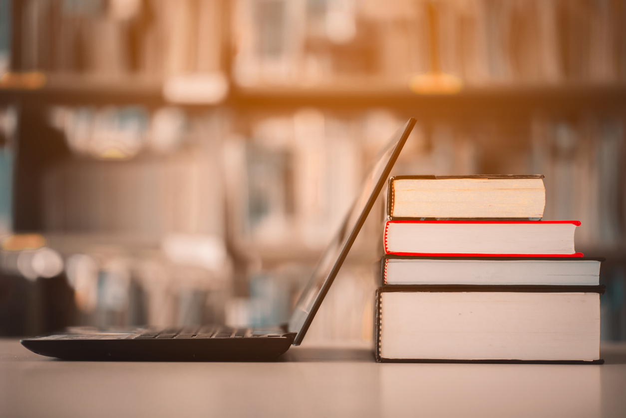 Laptop and books in a library