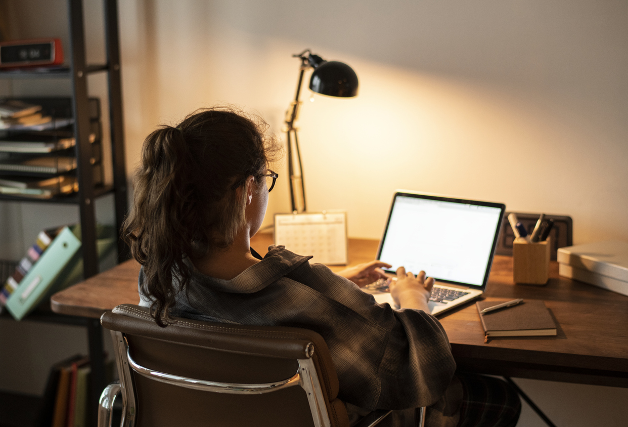 Law student sitting online exam on laptop