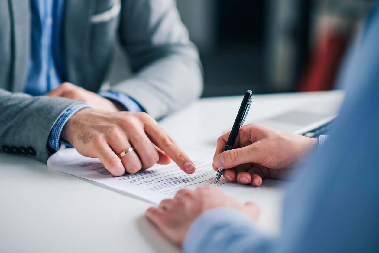 Lawyer directing client to sign document