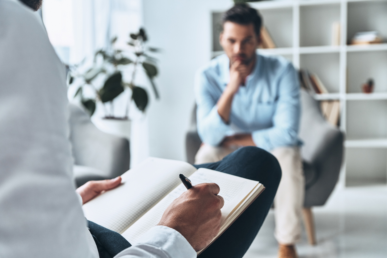 Lawyer listening to a client and taking notes