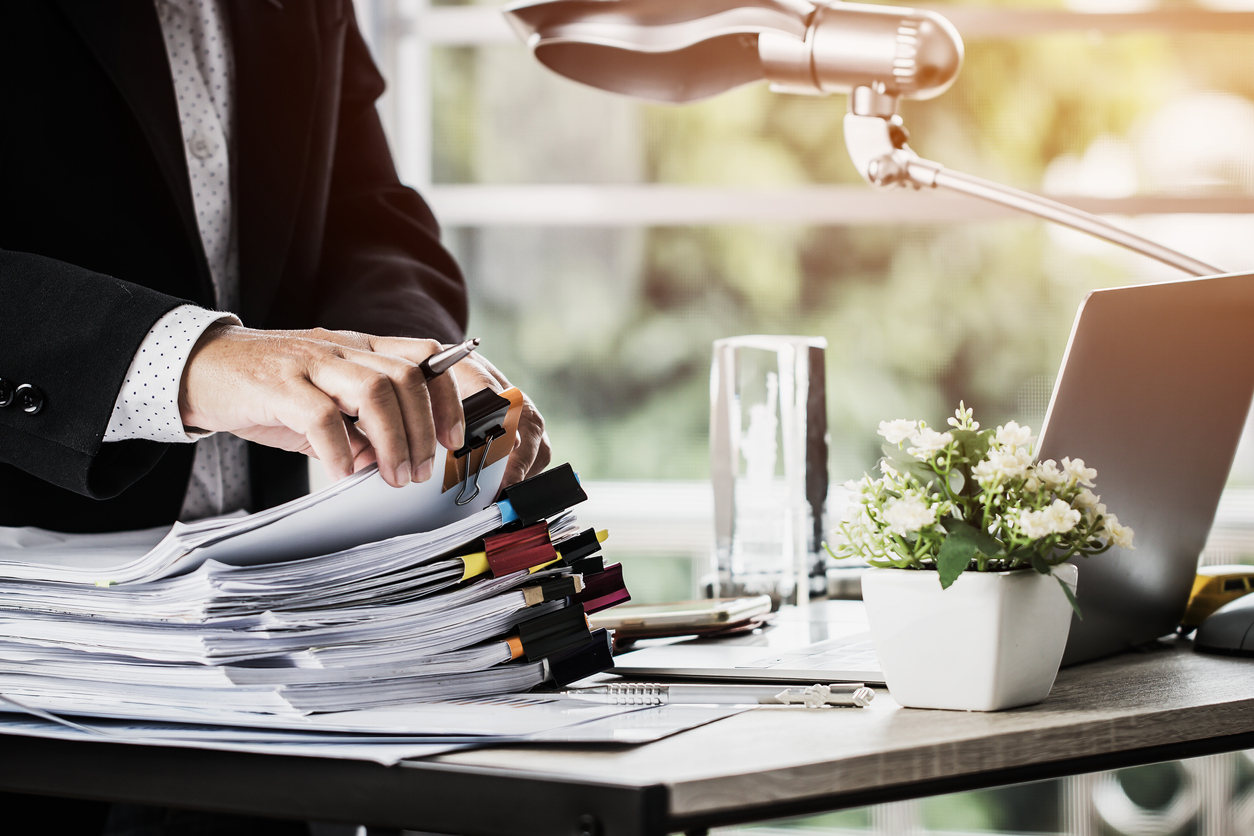 Lawyer with stacks of paper on desk