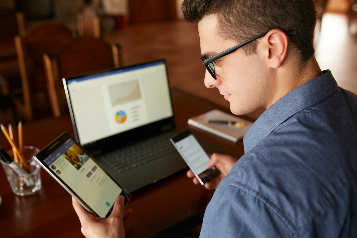 Attorney using laptop and two smartphones