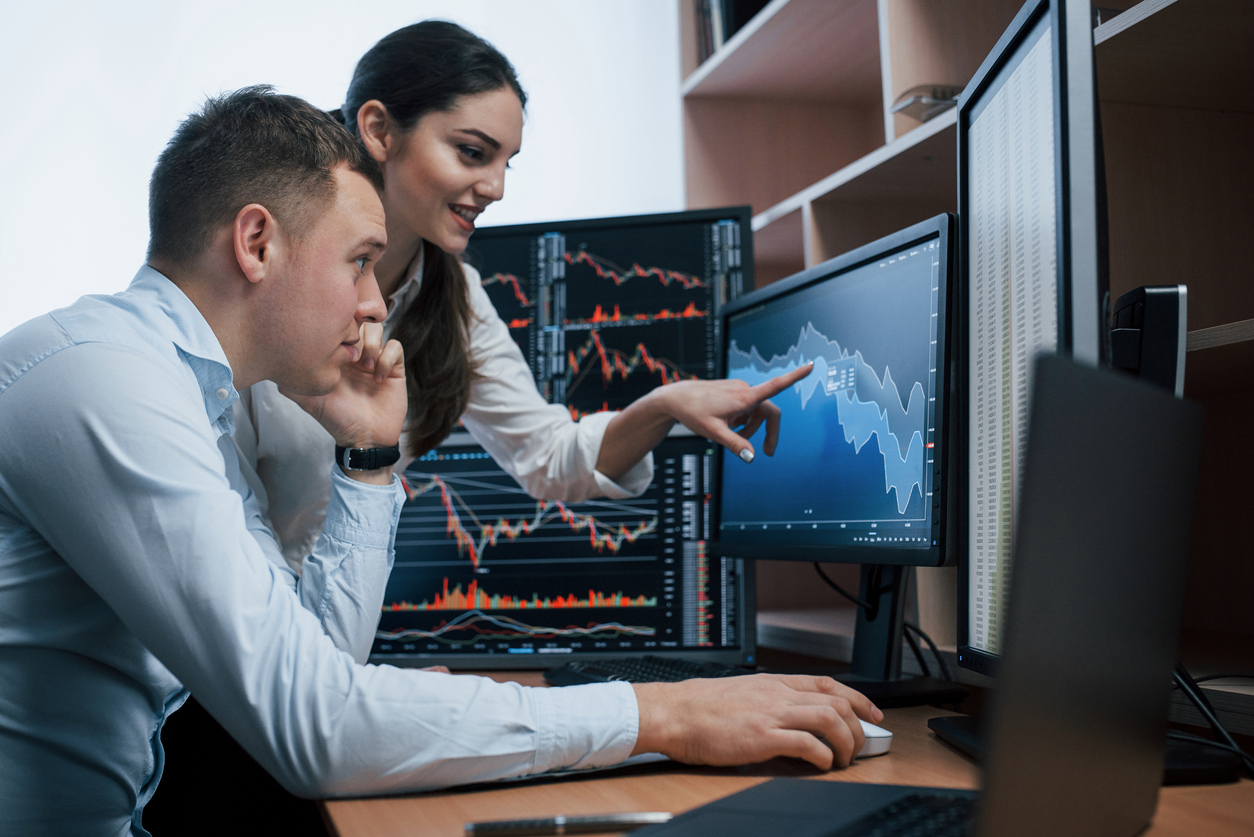 Finance team looking at computer monitors