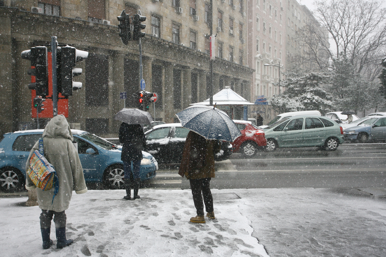 Pedestrians crossing a road in the snow