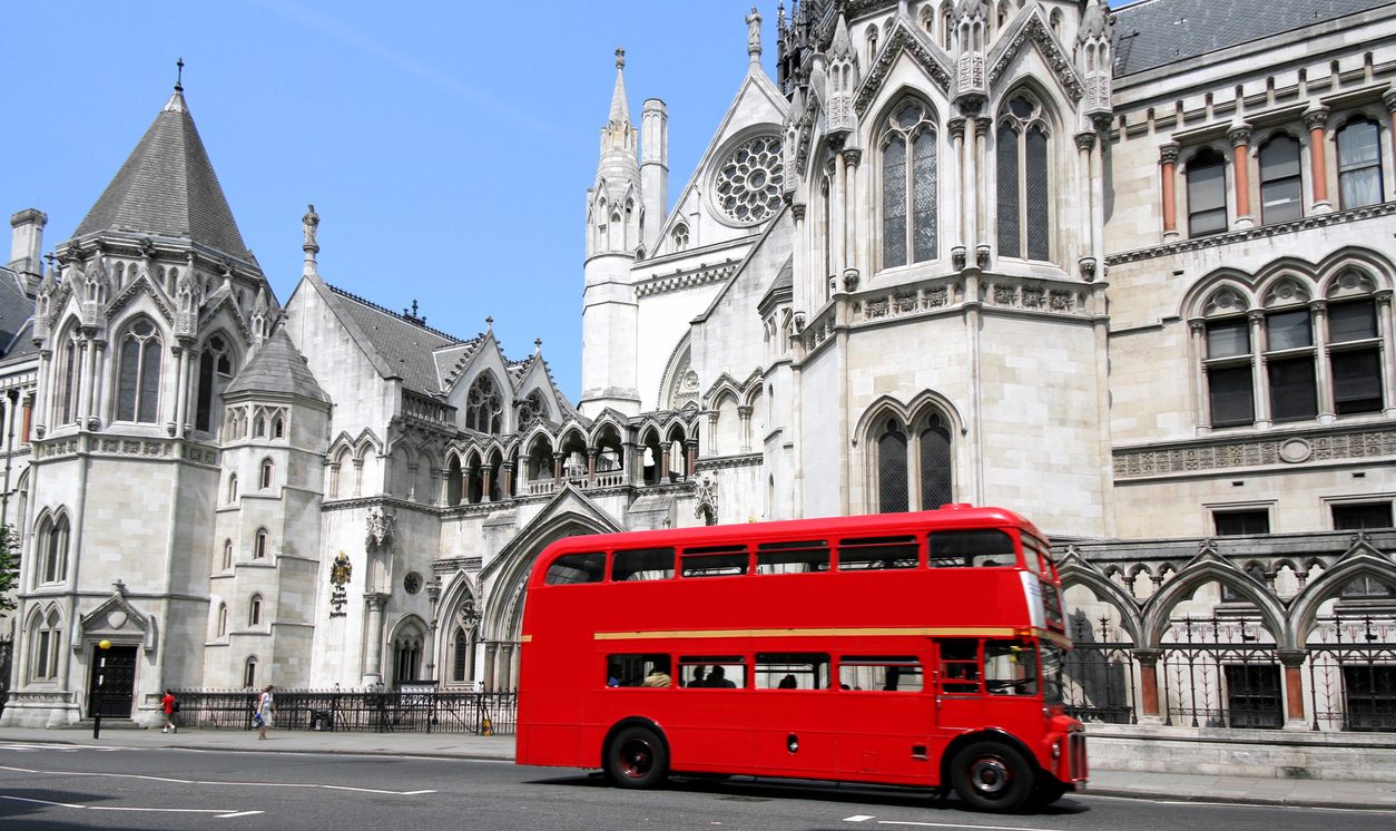 Red London bus outside the Royal Courts of Justice