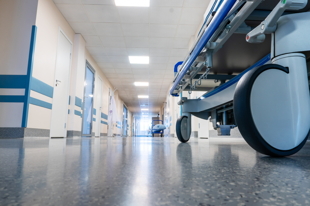 Wheeled medical bed in a hospital corridor