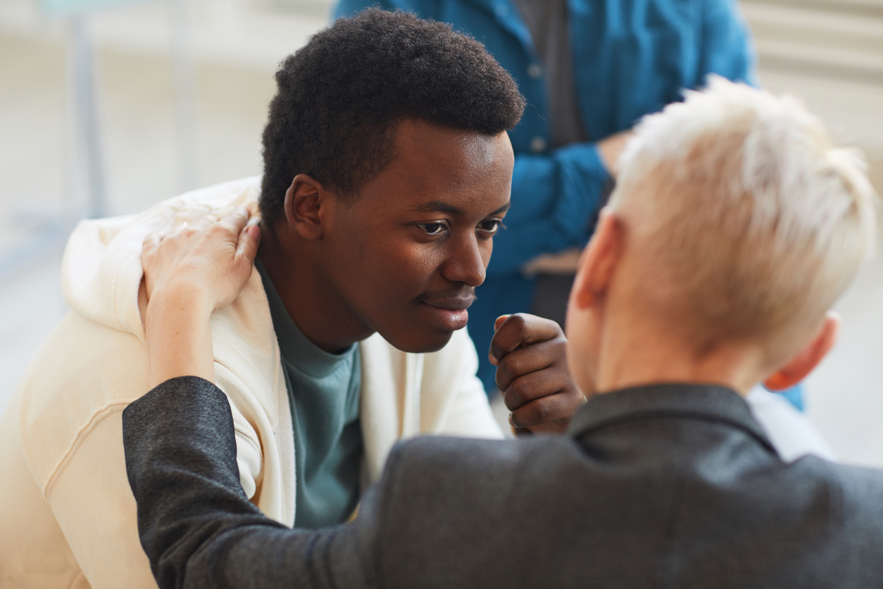 Young black man in rehabilitation support group