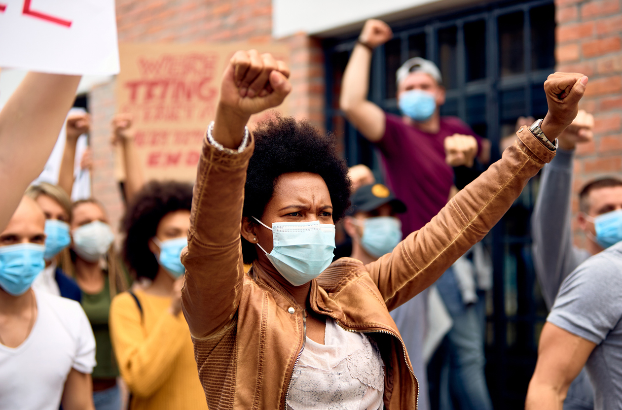 Black female activist wearing a face mask