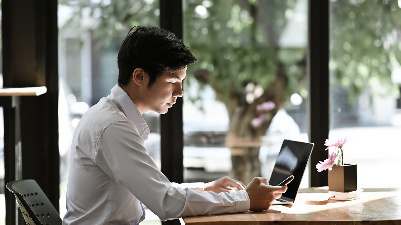 Lawyer in a modern office looking at a smartphone