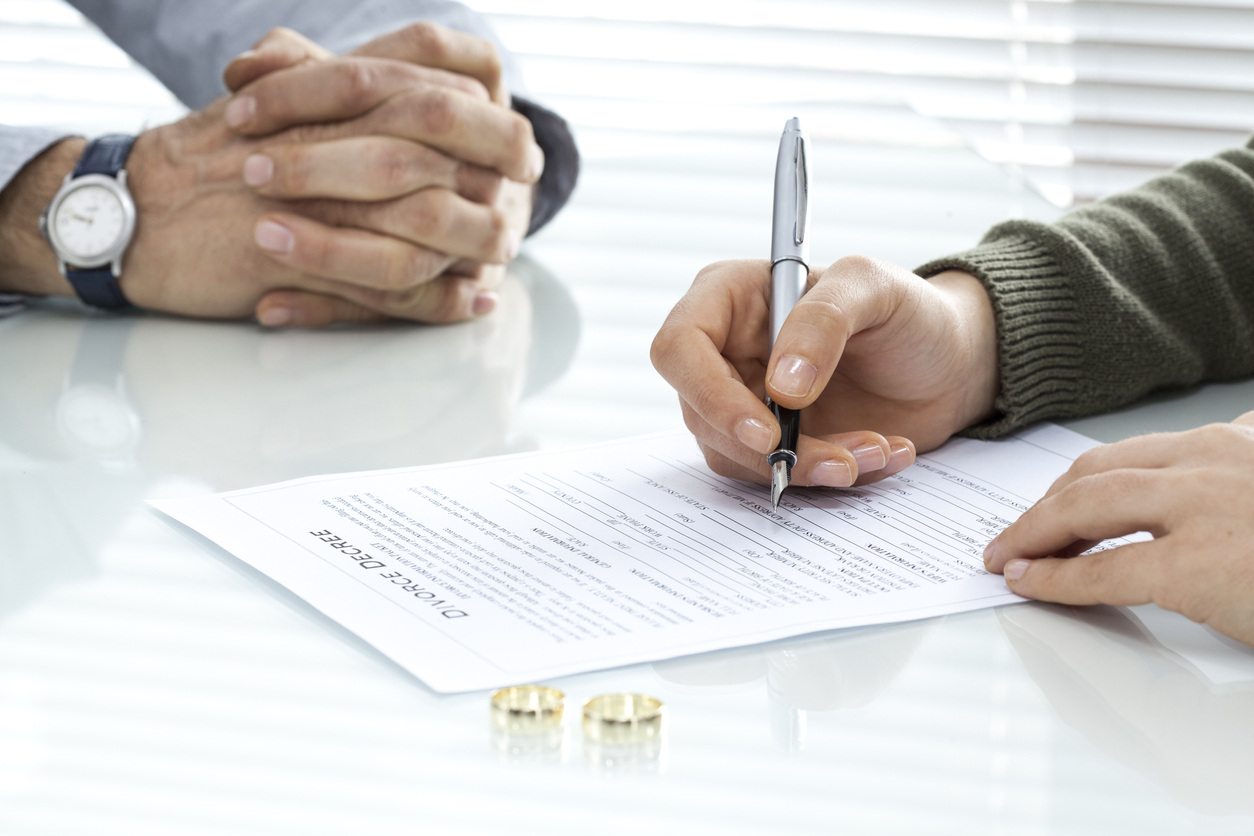 Woman signing divorce forms