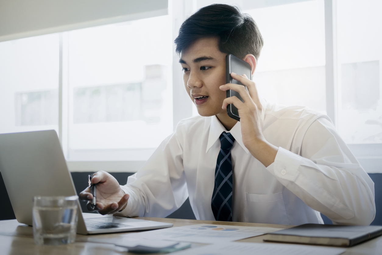 Young lawyer talking with a client on the phone