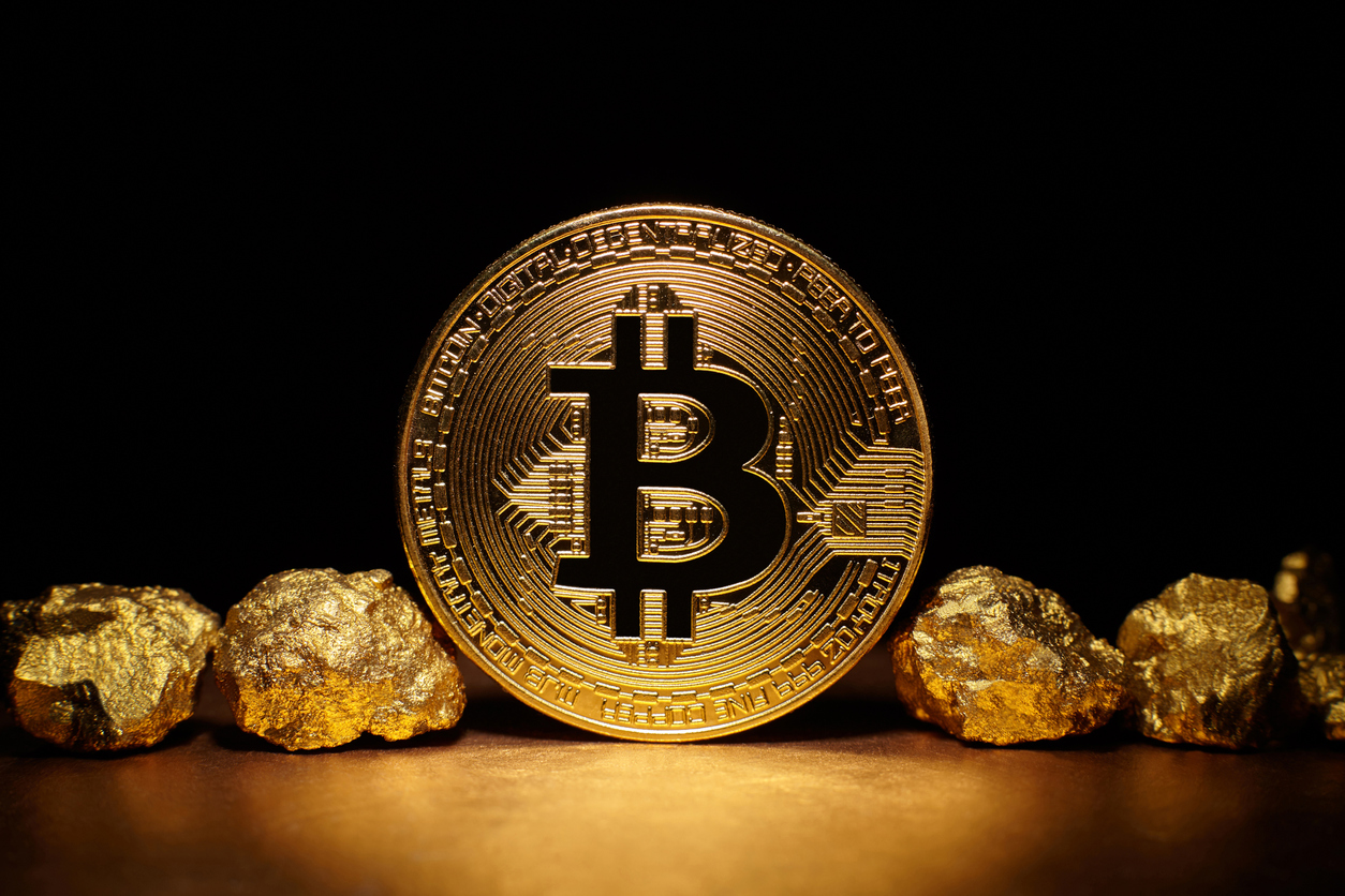 Bitcoin pictured between gold nuggets