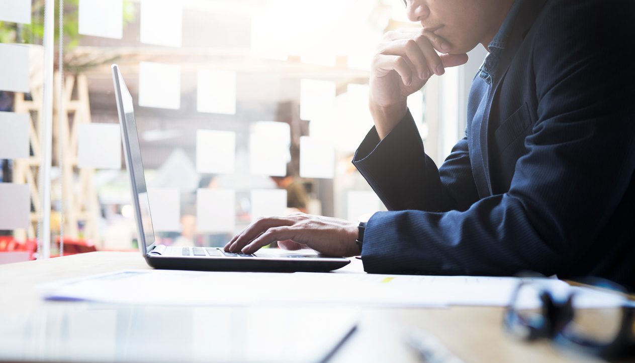 Businessman using a laptop in a modern office