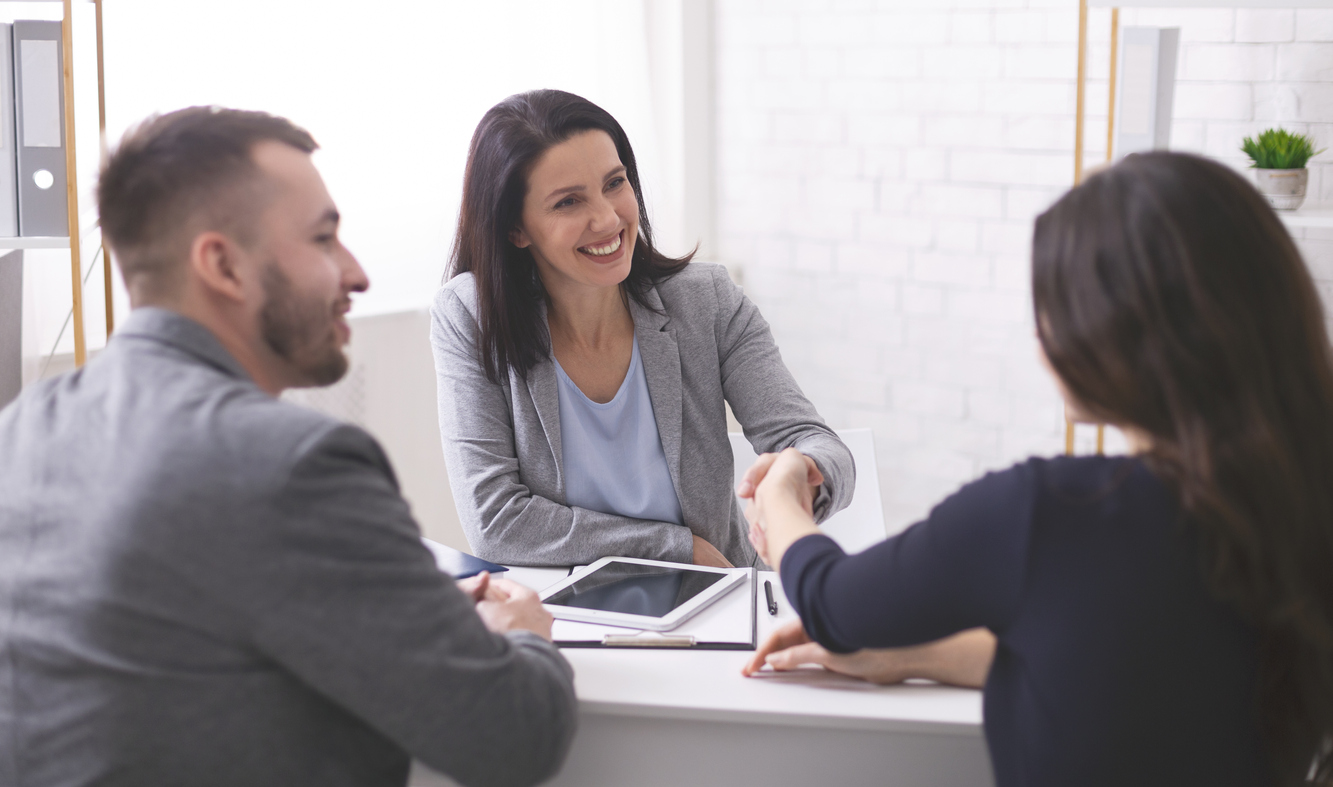 Lawyer having a positive meeting with two clients