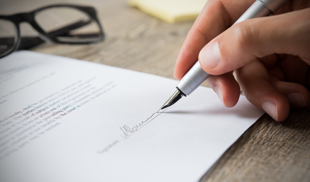 Man signing a legal document