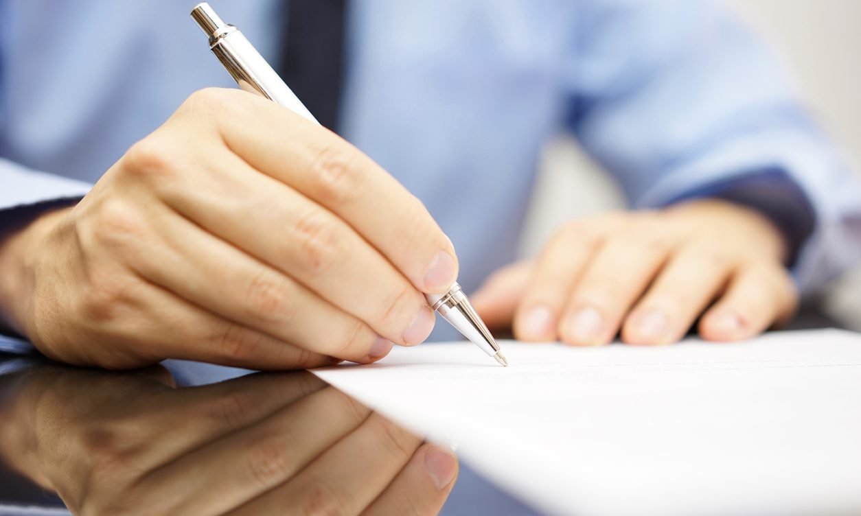 Businessman signing a will