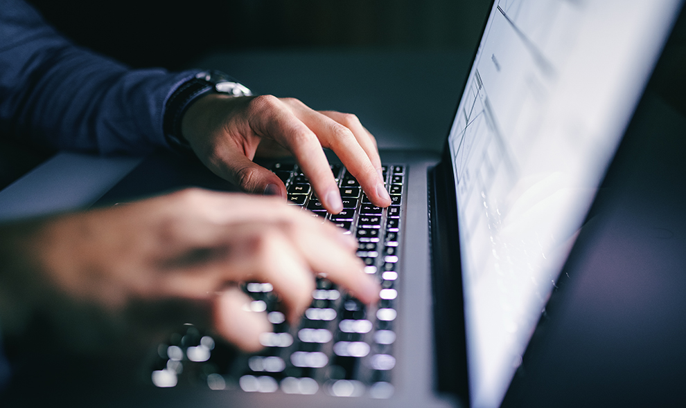 Man typing on a laptop