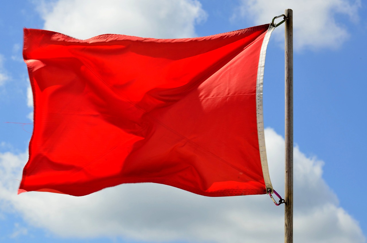 Red flag against sky blue