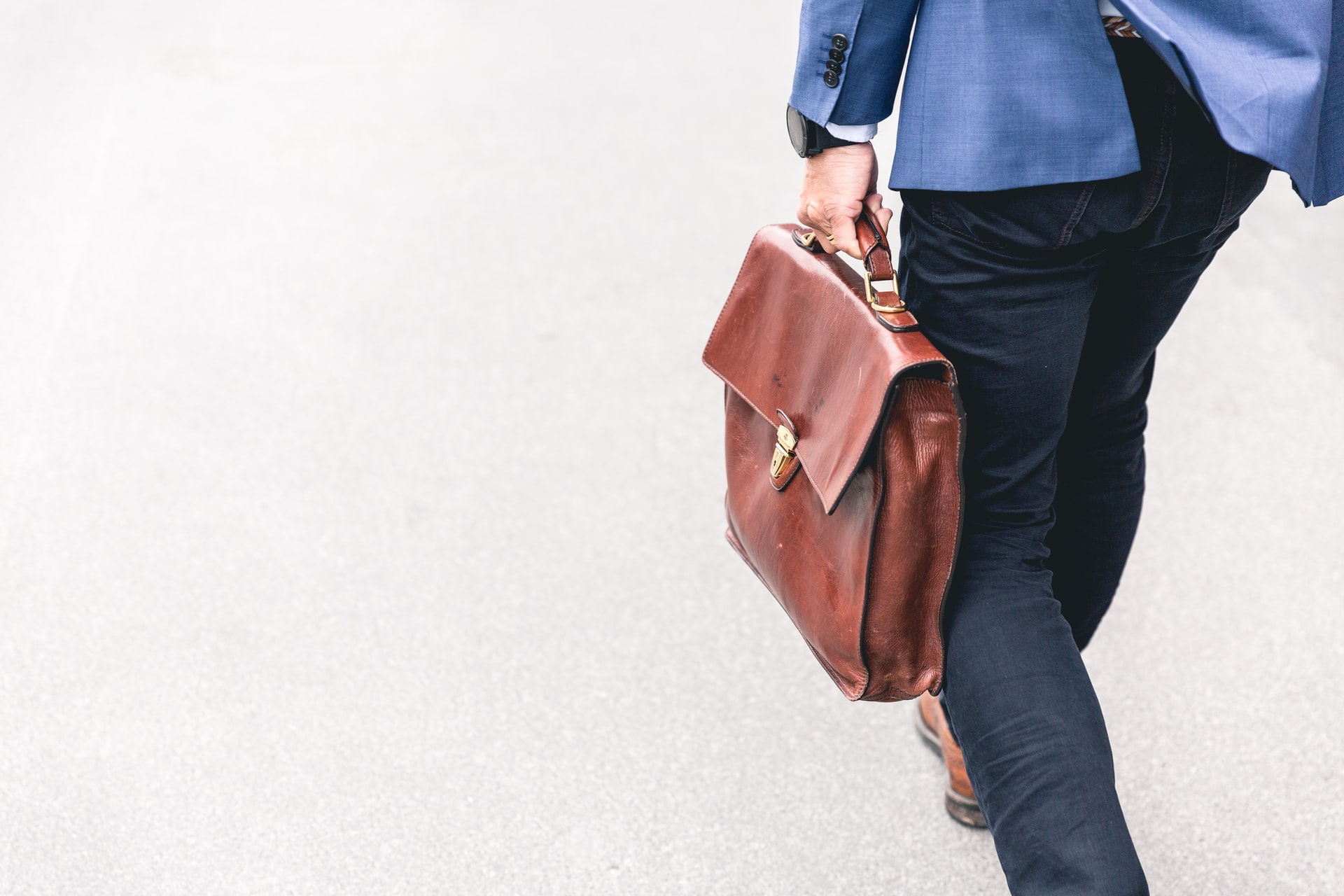 Lawyer walking and holding leather bag