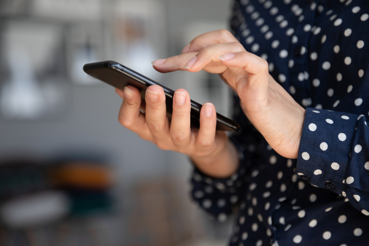 Woman using WhatsApp on mobile phone