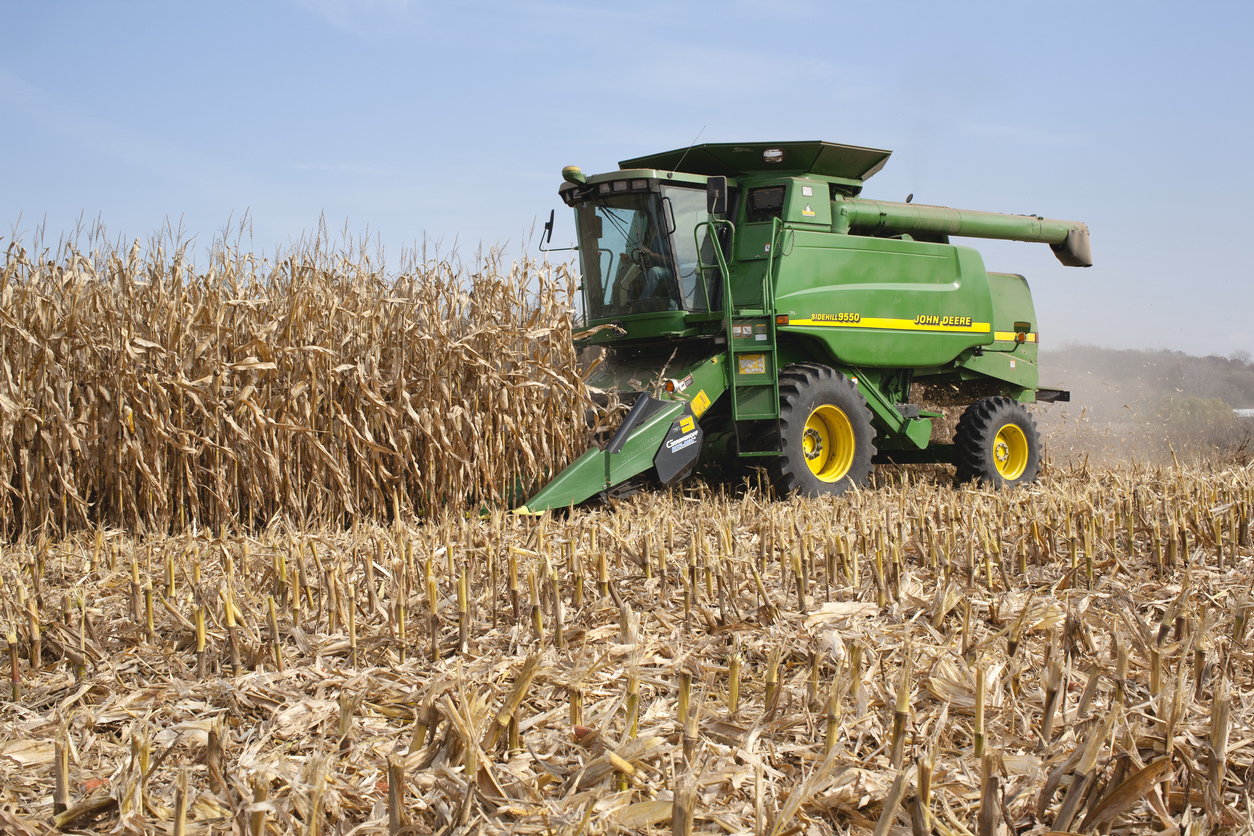 Deere combine harvests corn