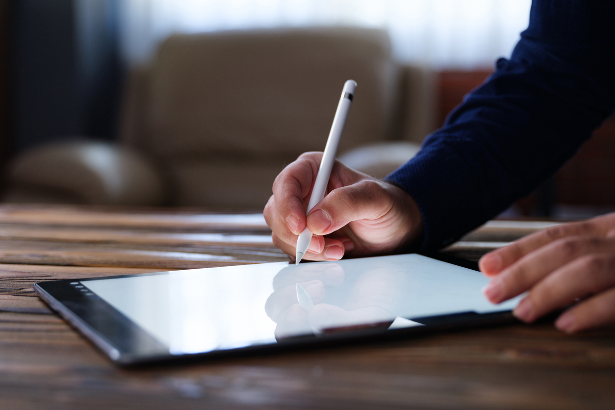 Hand signing e-signature on tablet