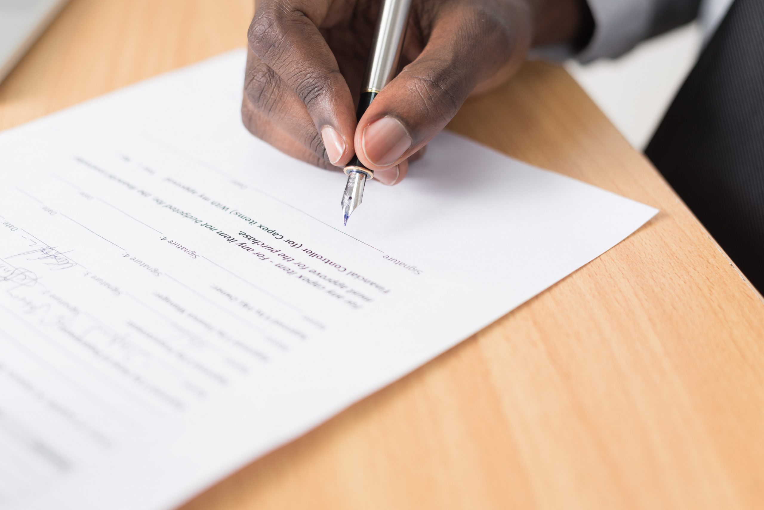 Hand signing a contract