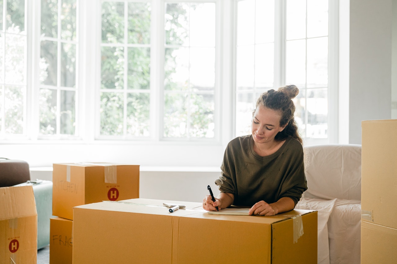 Woman packing boxes, ready to move abroad