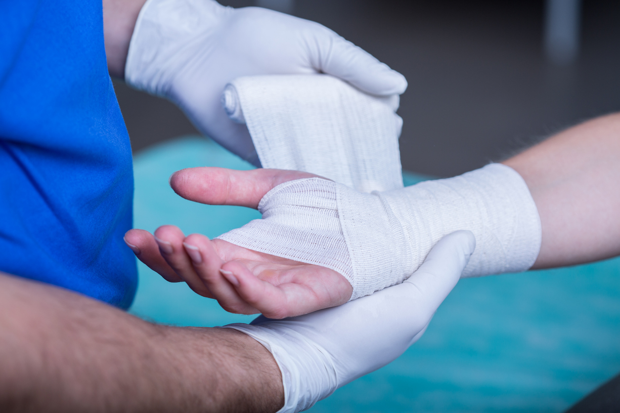 Medical professional bandaging hand