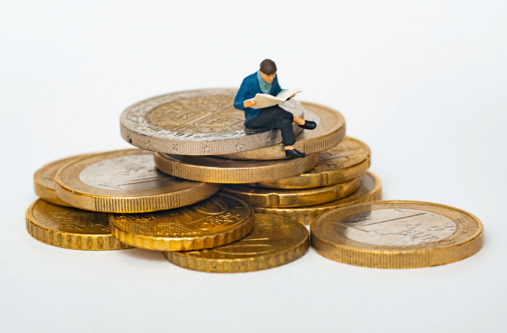 Figure sat on stack on coins representing legal marketing budget