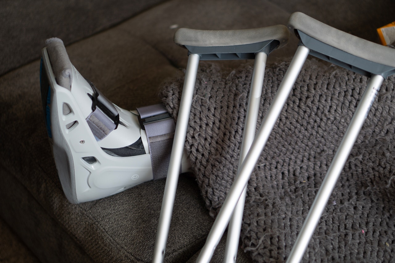 Foot in brace next to crutches; personal injury