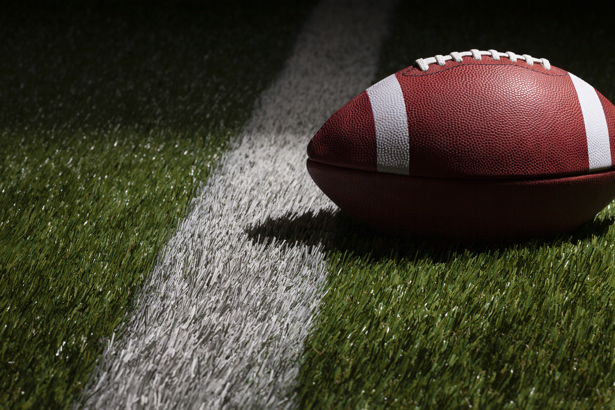 Low angle shot of American football on pitch