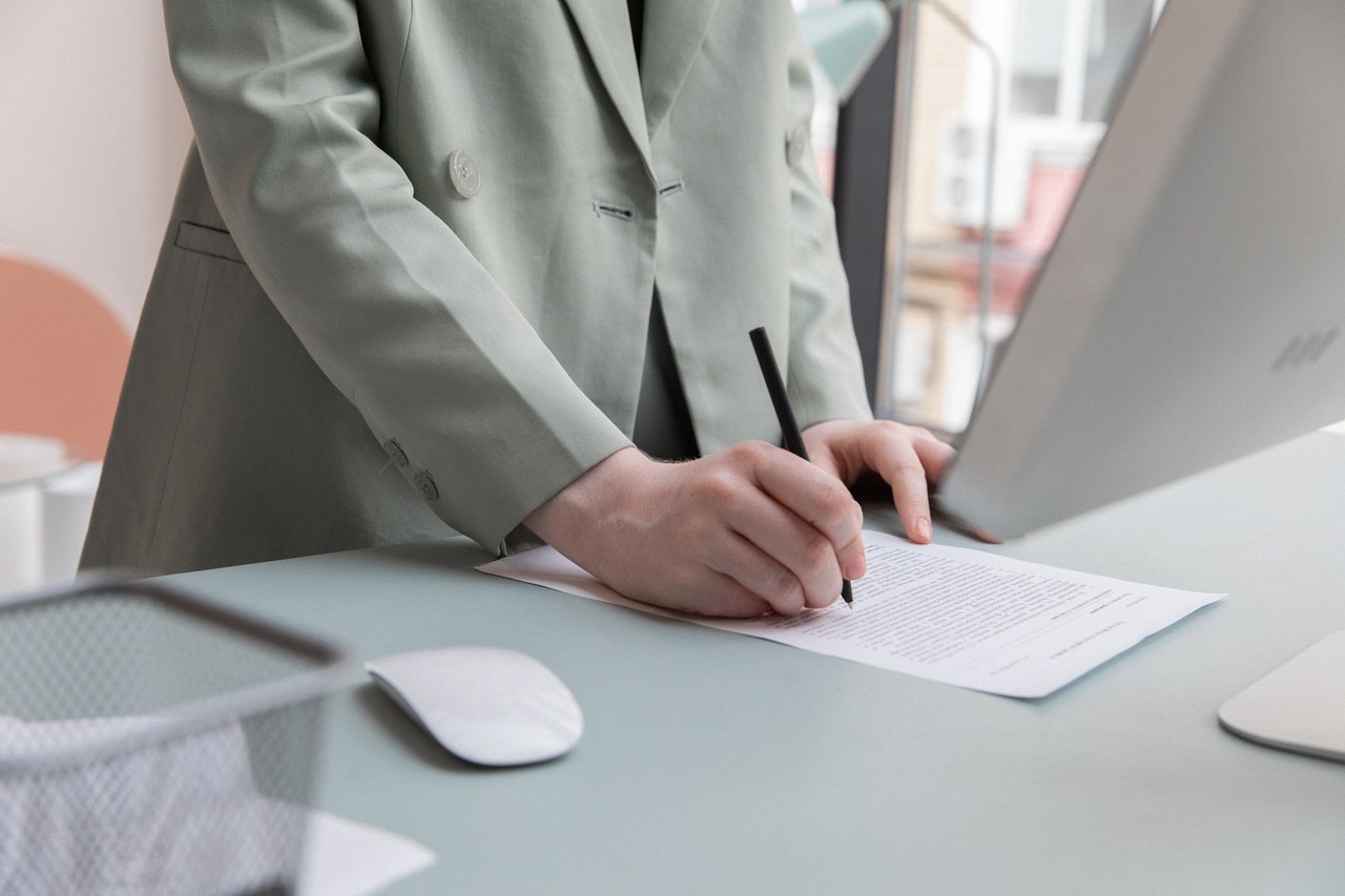 Woman signing demand letter