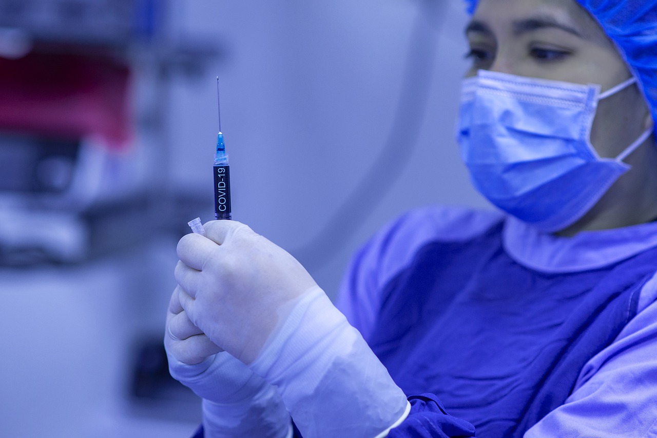 Nurse in scrubs with needle