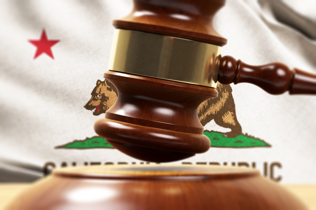 Wooden gavel in front of Californian flag