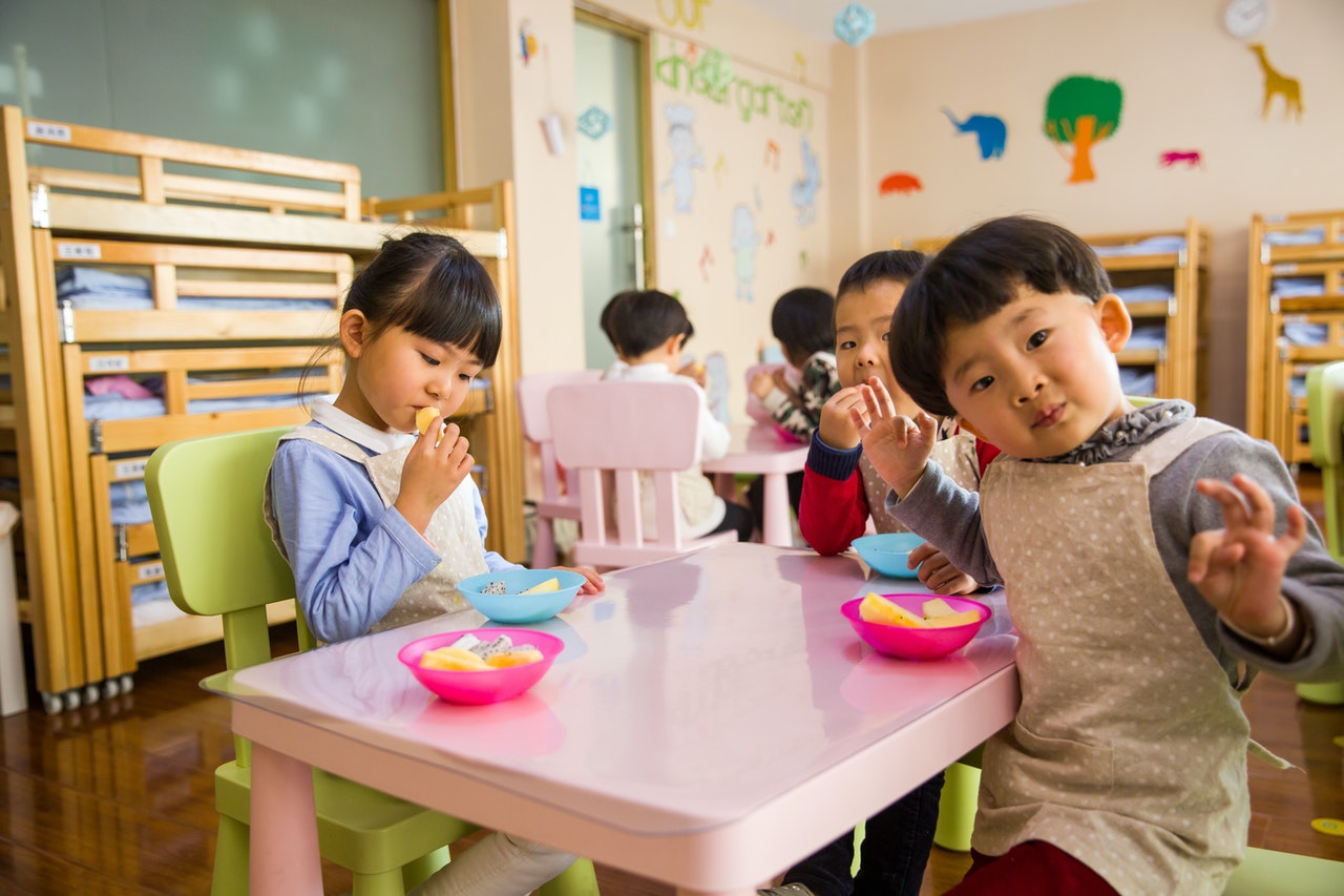 Children sat at table in daycare