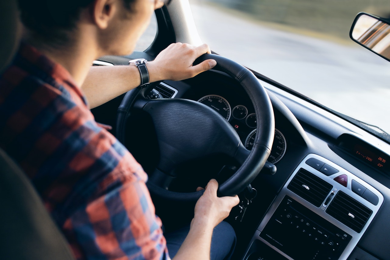 Woman behind steering wheel of car