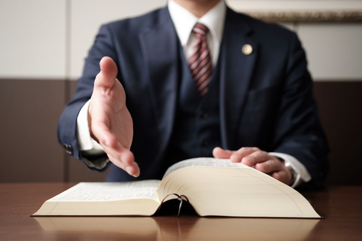 White male lawyer reaching out to shake clients hand