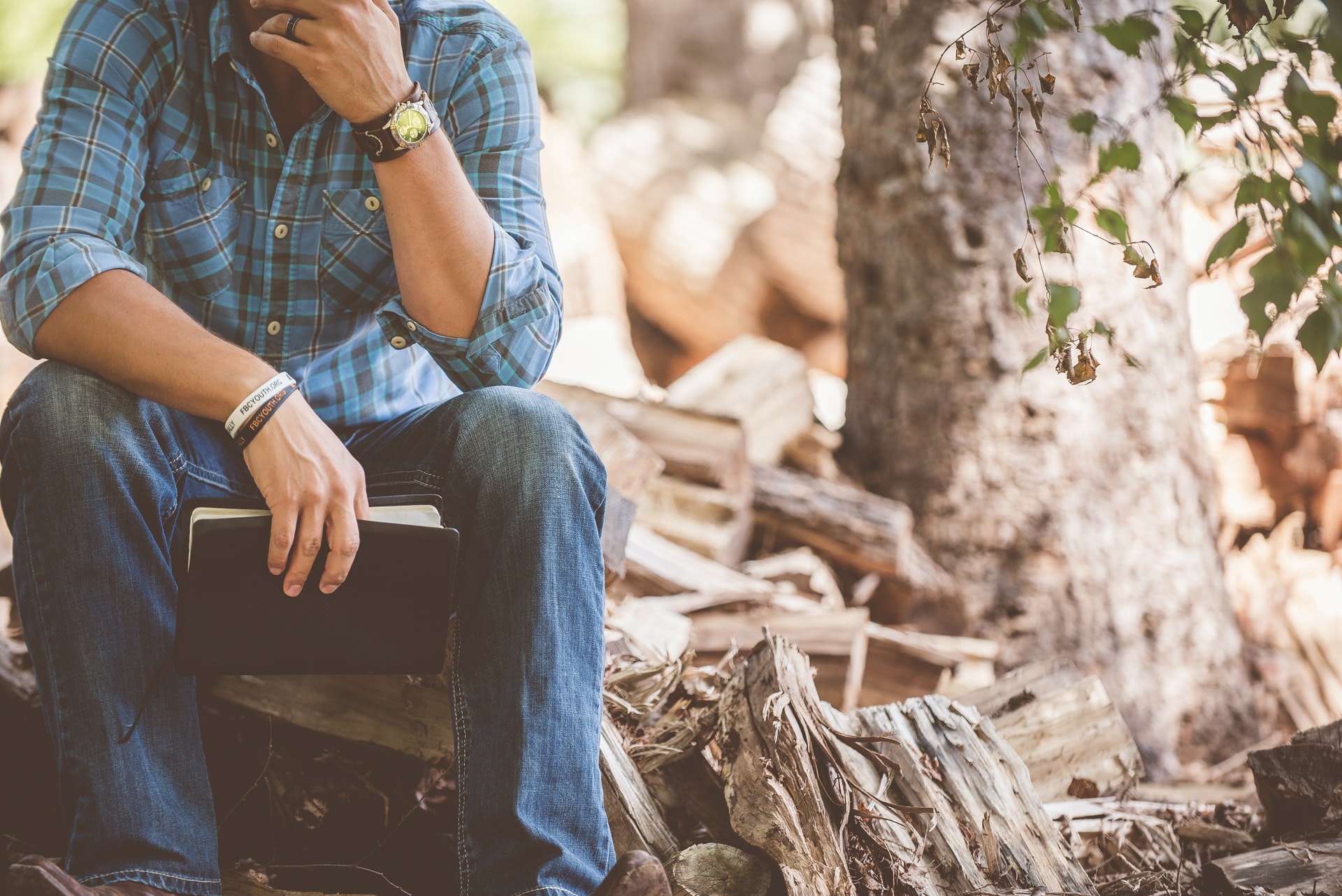 Man sat on log thinking