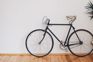 Bicycle up against white wall