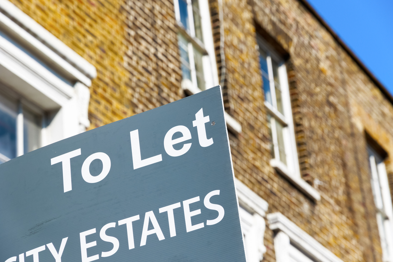 To Let property agency sign posted outside English terraced houses in Poplar, East London