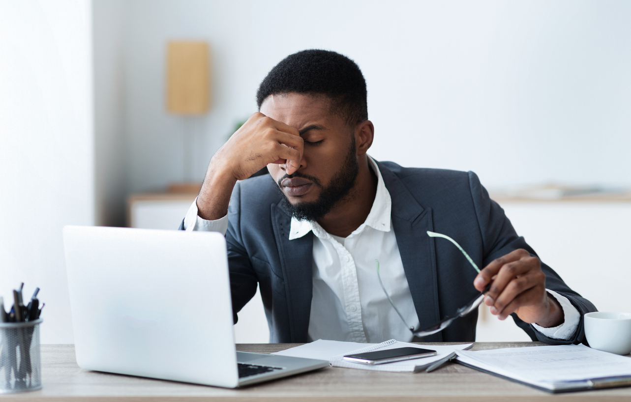 Stressed lawyer working at laptop