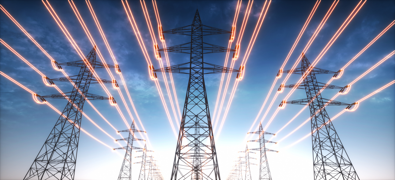 Electricity transmission towers with red glowing wires