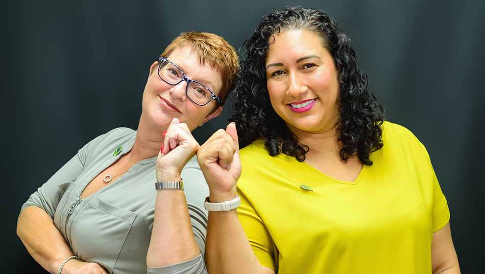 Chanda Glidden and Juliet Fenn, mediators, posing for a photoshoot.