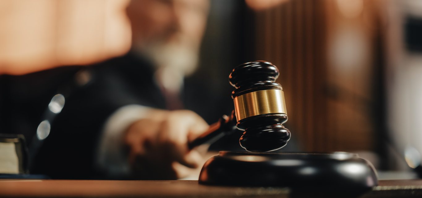 Court of Law and Justice Trial Session: Imparcial Honorable Judge Pronouncing Sentence, striking Gavel. Focus on Mallet, Hammer. Cinematic Shot of Dramatic Not Guilty Verdict. Close-up Shot.