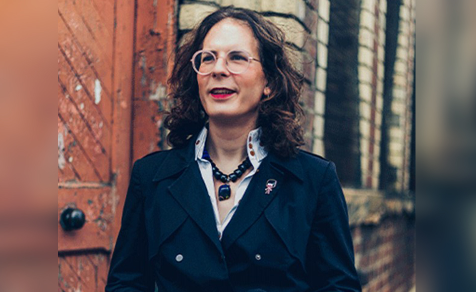 Female digital transformation expert standing in front of a building.