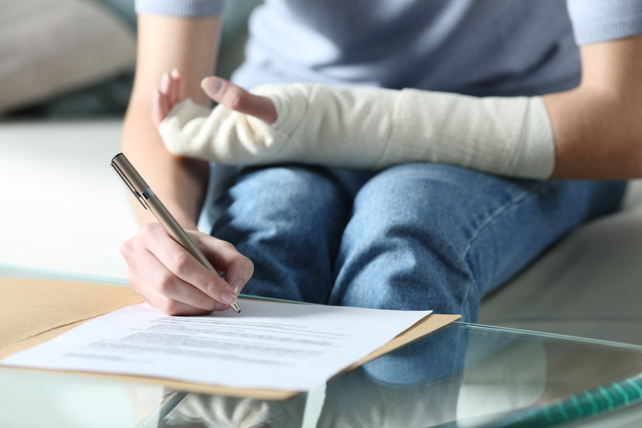 An injured person signing a contract